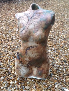 Grapevine impressed female figure. Crank clay with oxides and glaze.