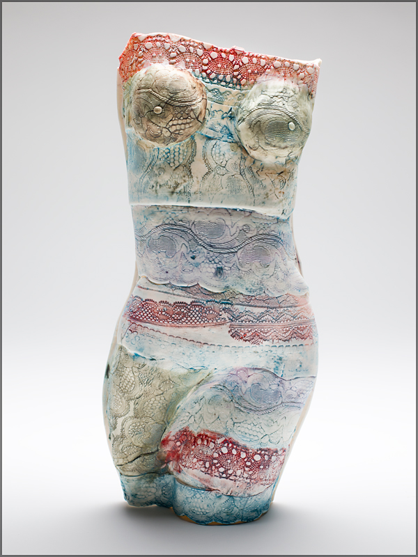 porcelain female figure with oxides and stains.